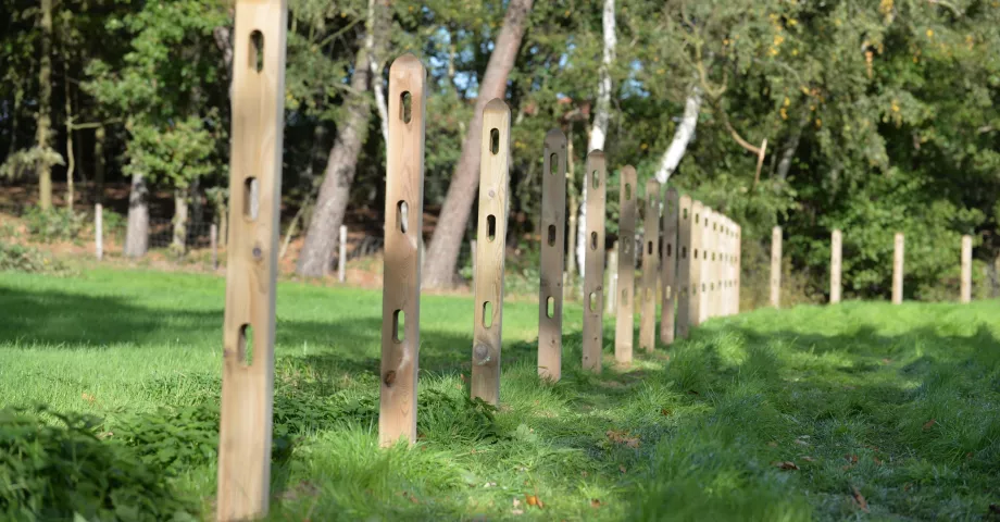 Houten vierkante palen met drie gaten voor de planken